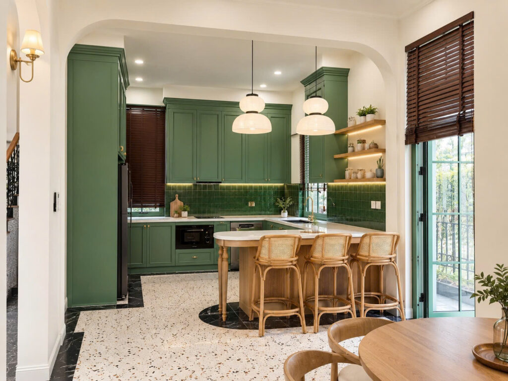 Không gian phòng bếp kết hợp bàn đảo sang trọng với tủ bếp màu xanh rêu độc đáo do SMJA Home thiết kế