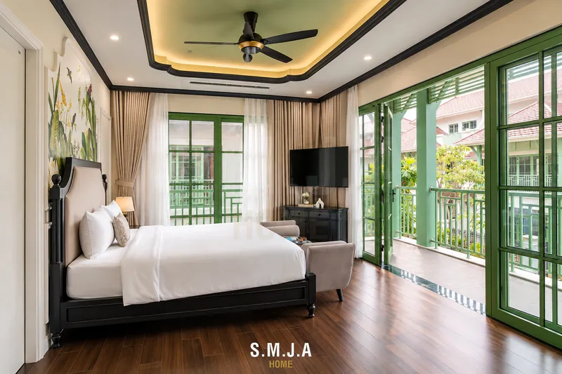 Phòng ngủ phong cách Indochine mở ra ban công thoáng rộng với hệ cửa kính khung xanh lớn đón trọn ánh sáng tự nhiên